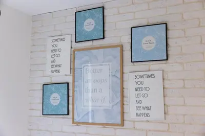 a wall with four framed pictures on a brick wall at PROMO Evergreen apartments in Kopaonik
