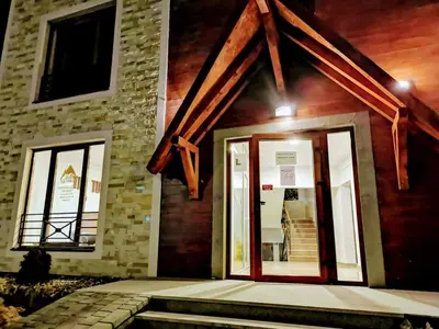 a front door of a building with windows at Apartman Pahulja - Milmari in Kopaonik