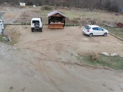 an aerial view of a parking lot with a white car at Vila Jelena in Crni Vrh
