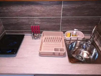 a kitchen counter with a sink with a strainer next to it at Vila Jelena in Crni Vrh