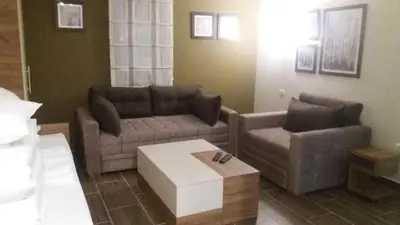 a living room with a couch and a coffee table at Villa Polaris in Kopaonik