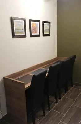 a conference room with a wooden table and black chairs at Villa Polaris in Kopaonik
