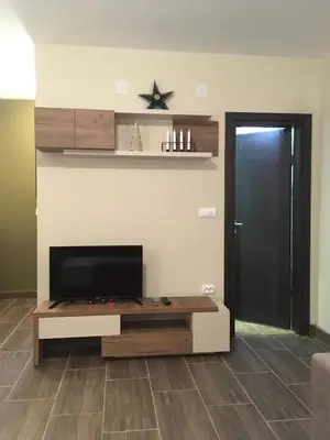 a living room with a tv and a table at Villa Polaris in Kopaonik