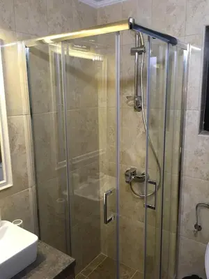 a shower with a glass door in a bathroom at Villa Polaris in Kopaonik