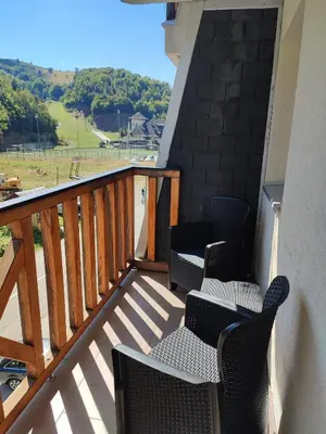 a balcony with chairs and a view of a field at Suncani apartman 26 in Brzeće