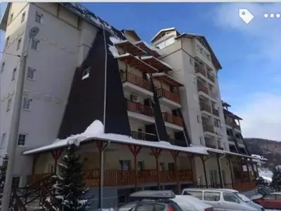 a large building with a boat on top of it at Suncani apartman 26 in Brzeće