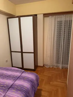 a bedroom with a bed and a large window at Suncani apartman 26 in Brzeće