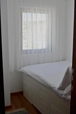 a bed in a room with a window at Apartman Marija, Vila Suri in Kopaonik