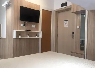 a bedroom with a bed and a flat screen tv at Peak Center Konaci in Kopaonik