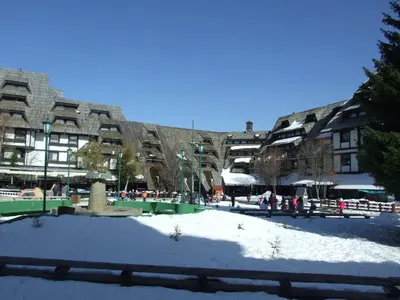 a snow covered park in front of a building at Peak Center Konaci in Kopaonik