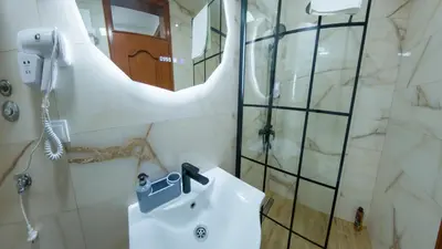 a bathroom with a sink and a shower at Apartmani Central & Free parking in Vrnjačka Banja