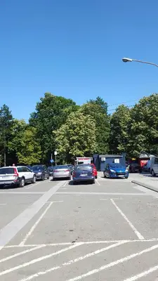 a parking lot with many cars parked in it at Apartmani Central & Free parking in Vrnjačka Banja