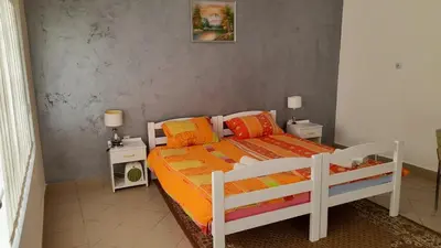 a bedroom with a bed and two night stands at Privatan smestaj knjazevac in Knjazevac.