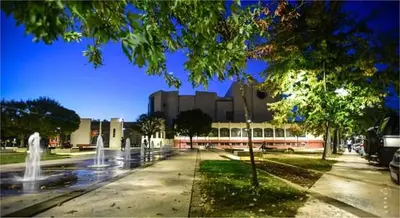 a building with water fountains in front of a building at Privatan smestaj knjazevac in Knjazevac.