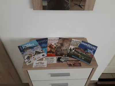 a table with magazines and books on it at Privatan smestaj knjazevac in Knjazevac.