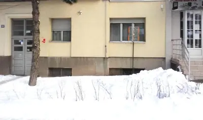 a pile of snow in front of a building at Apartman Veljic in Niš