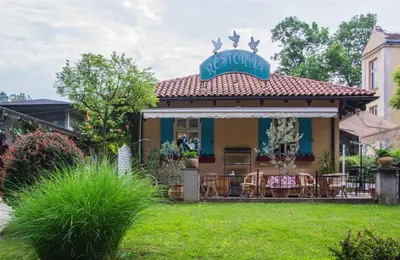 a house with a restaurant with a sign on it at Vila Ljubica in Vrnjačka Banja