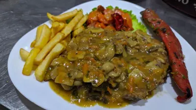 a plate of food with meat and french fries at B&B Bebinac in Leskovac
