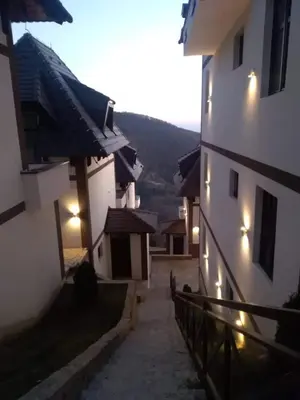 an alley way between two buildings with lights on them at Apartman D11 Dvori in Kopaonik