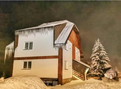 a painting of a house in the snow at Apartman Jana do Kraljevih cardaka in Kopaonik