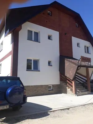 a car parked in front of a building at Apartman Jana do Kraljevih cardaka in Kopaonik