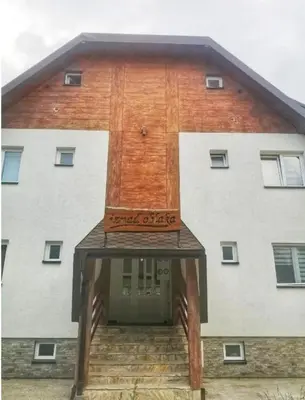 a building with a sign on the front of it at Apartman Jana do Kraljevih cardaka in Kopaonik