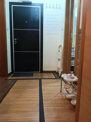 a black door in a room with a wooden floor at Ljubica in Brzeće