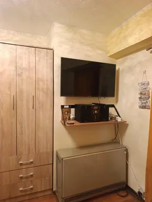 a living room with a tv and a cabinet at Ljubica in Brzeće