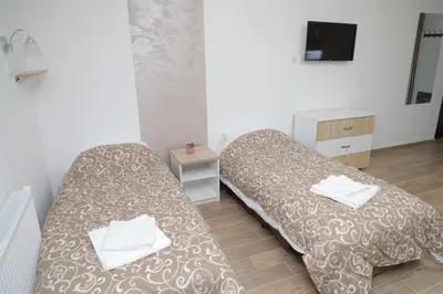 a room with two beds with towels on them at BAJKA in Crni Vrh