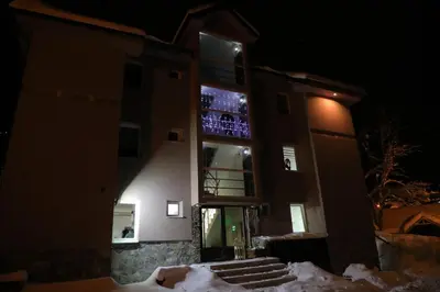 a building with a lit up window at night at BAJKA in Crni Vrh