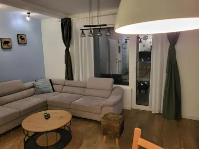 a living room with a couch and a table at Apartman Jovanovic Kopaonik in Kopaonik