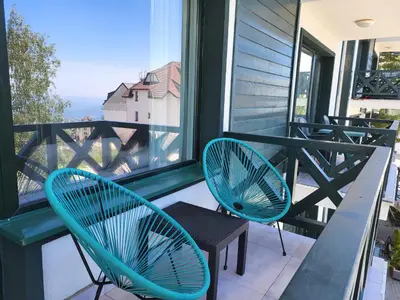 two chairs and a table on a balcony at Apartman Jovanovic Kopaonik in Kopaonik