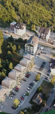 an aerial view of a parking lot next to a building at Apartman Jovanovic Kopaonik in Kopaonik