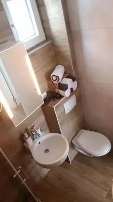 a small bathroom with a sink and a toilet at Apartman Jovanovic Kopaonik in Kopaonik