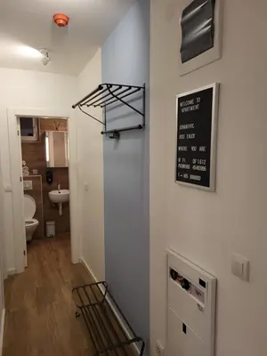 a room with a sign on the wall and a bathroom at Apartman Jovanovic Kopaonik in Kopaonik