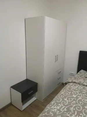 a bedroom with a large white cabinet next to a bed at Iznad Oblaka Apartman 8 in Kopaonik