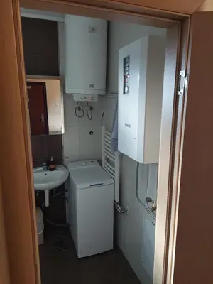 a small bathroom with a sink and a toilet at Apartments 1A JollyKop in Kopaonik