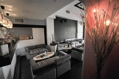 a waiting room with couches and tables in a salon at B&B Rose in Vranje