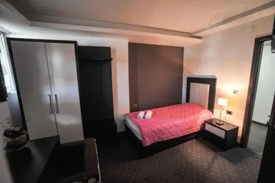 a bedroom with a bed with a red blanket at B&B Rose in Vranje