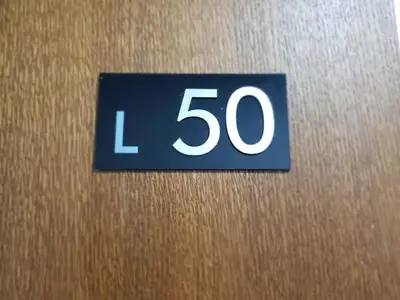 a sign with the number on a door at Milmari RELAX apartment in Kopaonik