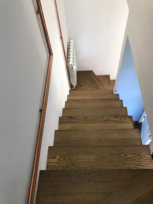 a staircase with wood floors and a stair case at Jules Verne apartments in Kopaonik