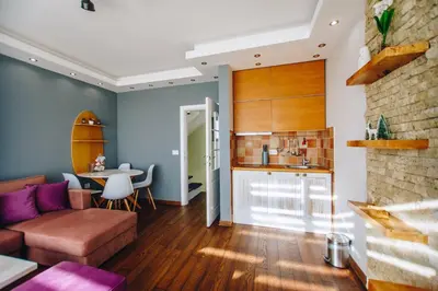 a living room with a couch and a table at Jules Verne apartments in Kopaonik