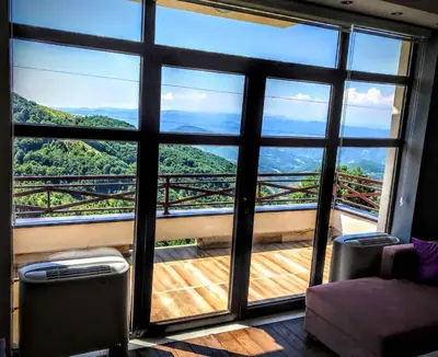 a room with a large window with a view at Jules Verne apartments in Kopaonik