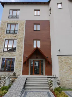 a house with a wooden front door at Milmari L44 in Kopaonik