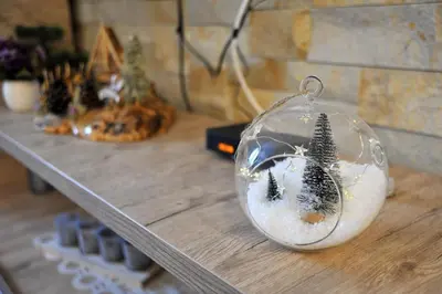 a glass ornament with trees in it on a table at Milmari L44 in Kopaonik