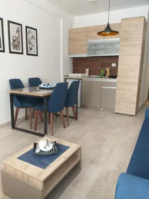 a kitchen and dining room with a table and chairs at Milmari L44 in Kopaonik