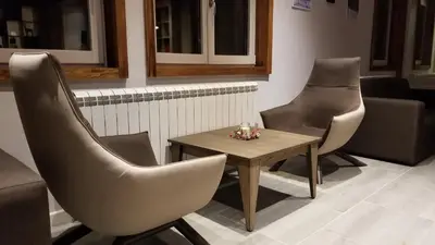 two chairs and a table in a waiting room at Top Lux Zupa in Kopaonik