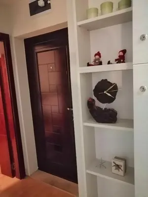 a room with a door and a shelf with an umbrella at Apartment Lavina Kopaonik in Kopaonik
