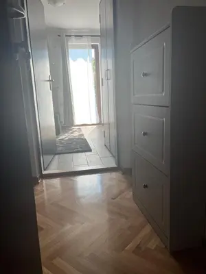 a bathroom with a mirror and a wooden floor at Guest House Vila Pobeda in Vrnjačka Banja