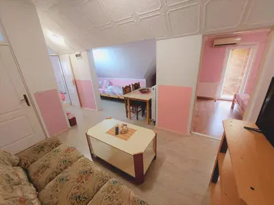 a living room with a couch and a table at Apartments Nikolić in Soko Banja